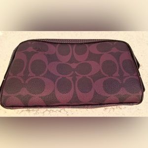 Coach purple clutch with zipper arrow 7” x 4”. Clutch still has tags.